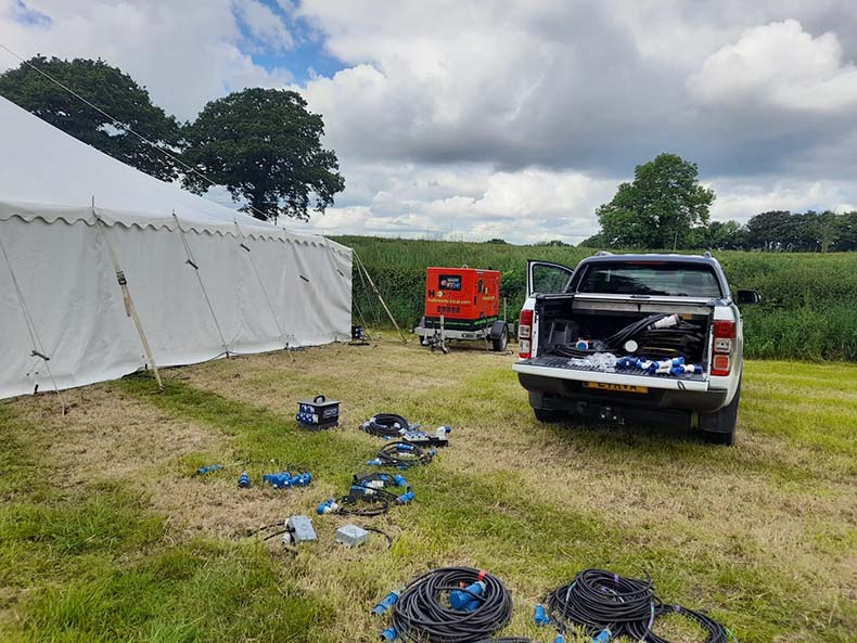 Setting up the power cabling for a marquee wedding